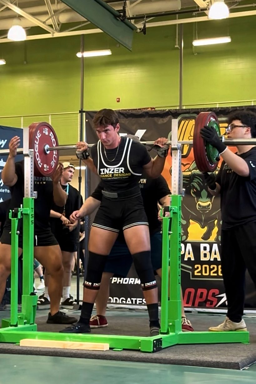 Aaron Akouka unracking a squat at a USA Powerlifting meet