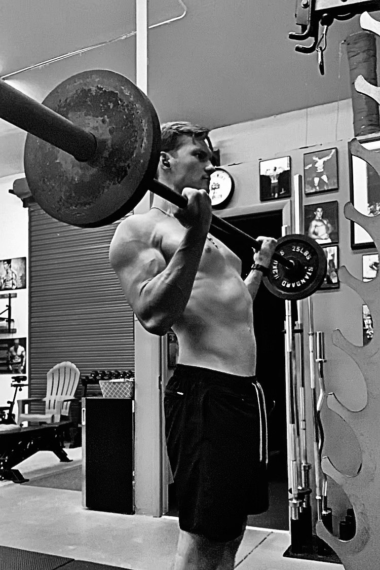 Simon Akouka front squatting at The Art of Muscle
